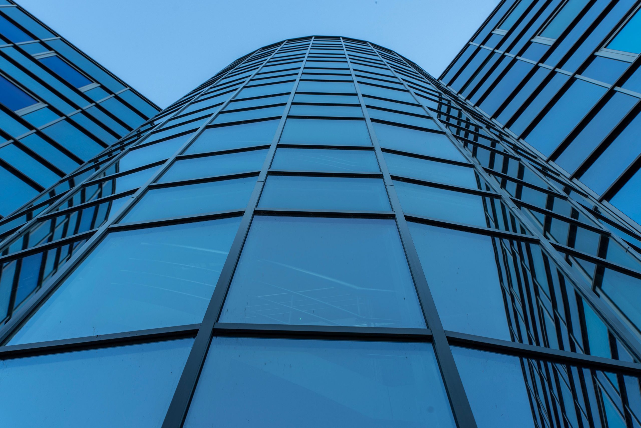 Behind the Headlines: How Corporate Mega-Lawsuits Actually Get Paid Out Reflective glass facade of a modern corporate skyscraper, representing a corporate defendant in a mega-lawsuit