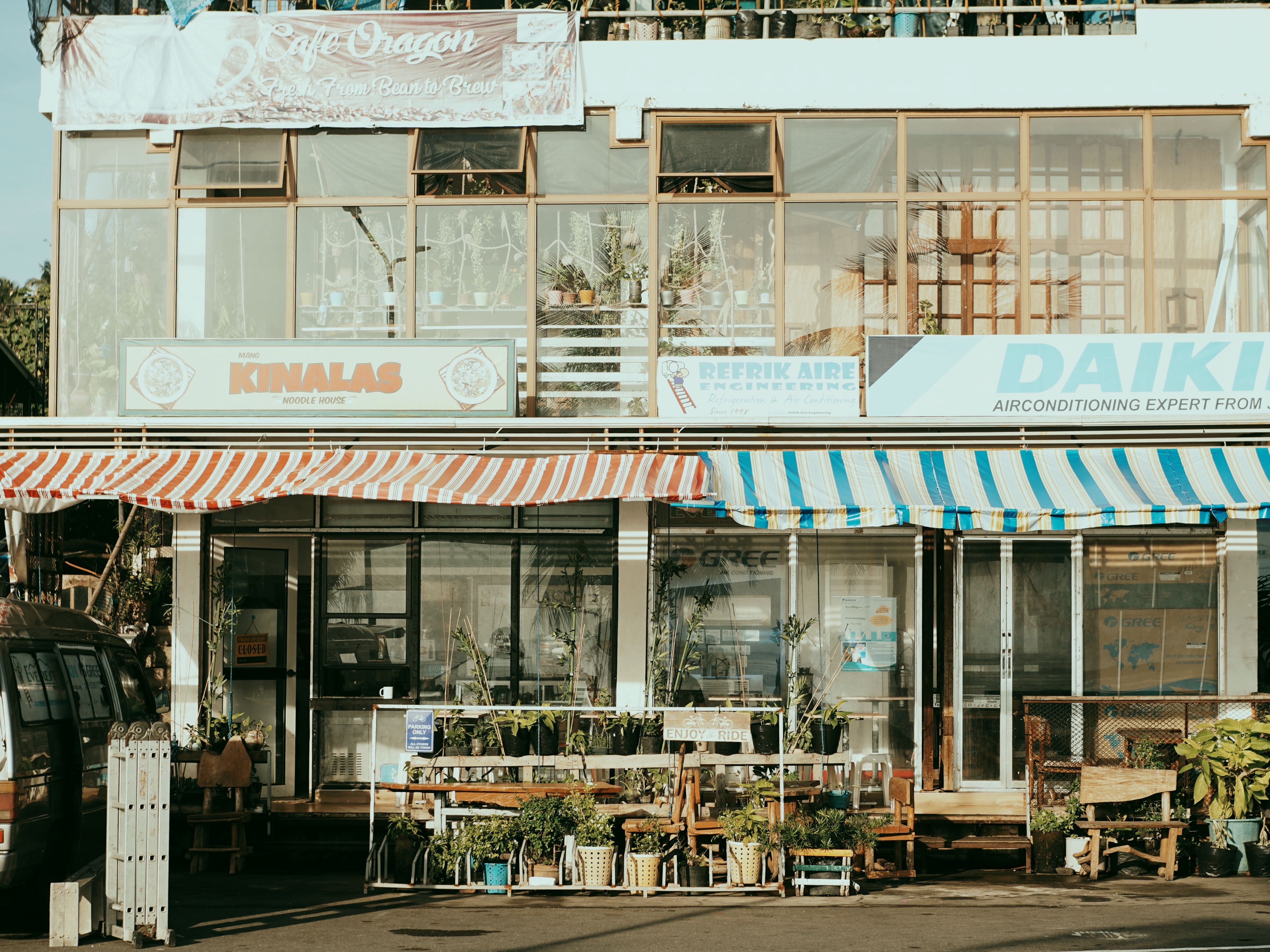 Charming main street with local small business shops and colorful striped awnings