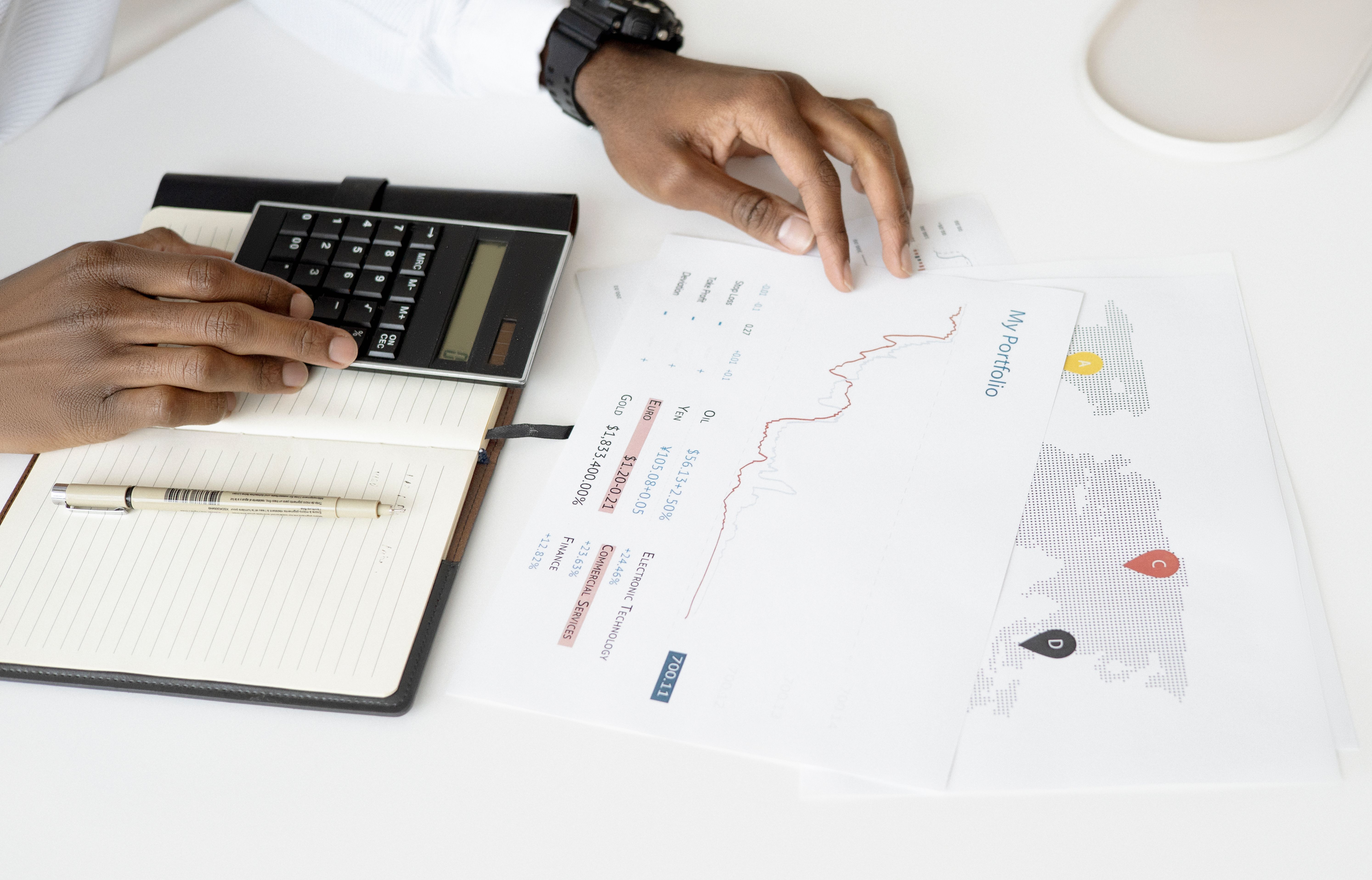 Person analyzing financial documents with a calculator, representing investment evaluation in litigation funding.